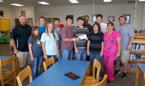 Smackover HS Huddle leaders presented a check to the Clark family. Front Row (L to R): Katherine Jerry, Kayla Green, Logan Clark, Bryan & Jacob Clark (VHS students) along with their mom Back Row (L to R): Coach David Preston, Jackson Martin, Cooper Thurmon, Joseph Clark, Tripp Evans, Coach Mikey Moss 